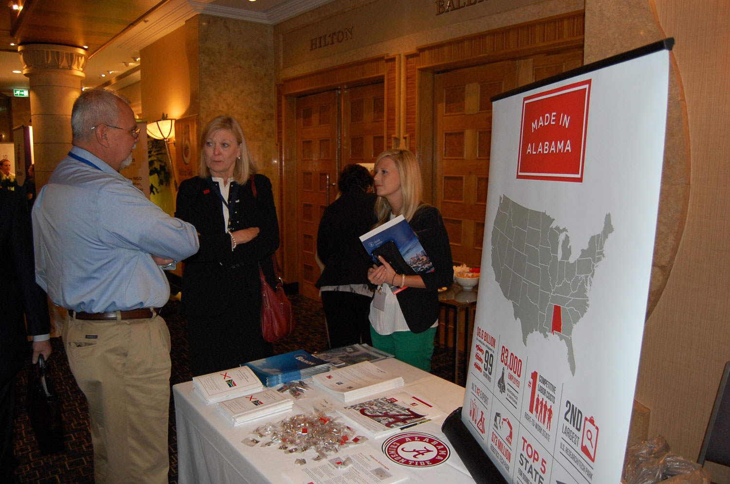 Commerce’s Hilda Lockhart, center, chats at the Made In Alabama booth at the 2015 Trade Winds conference in South Africa.