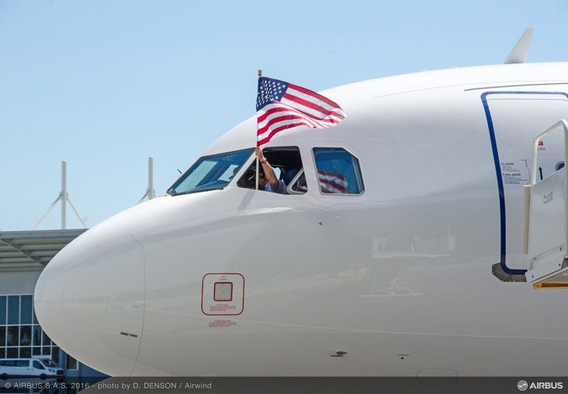 A U.S. flag waves from the cockpit of the first Alabama-made Airbus A321 after the test pilots complete the plane’s maiden flight. (Image: Airwind via Airbus)