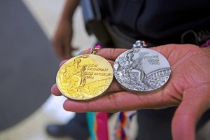 Lillie and her gold and silver medals. (Meg McKinney/Alabama NewsCenter)