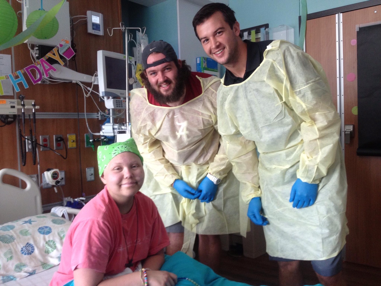 While at Children’s Hospital, Frances Grace Hirs was visited by Alabama football players AJ McCarron, right, and Austin Shepherd.